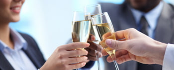 business guests toast their champagne glasses